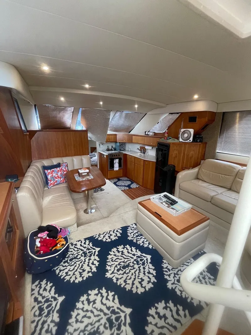 Slide: The Image of Interior of 2002 Silverton 392 Motor Yacht with cozy seating and elegant decor. - 27