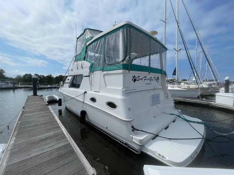 Slide: The Image of 2002 Silverton 392 Motor Yacht docked at marina under cloudy sky. - 3