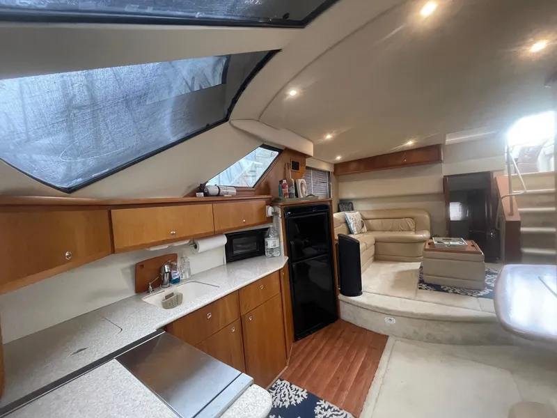 Slide: The Image of Interior of 2002 Silverton 392 Motor Yacht with modern kitchen and cozy seating area. - 33