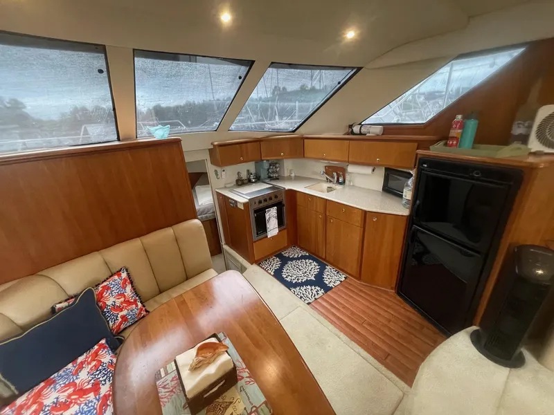 Slide: The Image of Interior of 2002 Silverton 392 Motor Yacht with kitchen and seating area. - 34