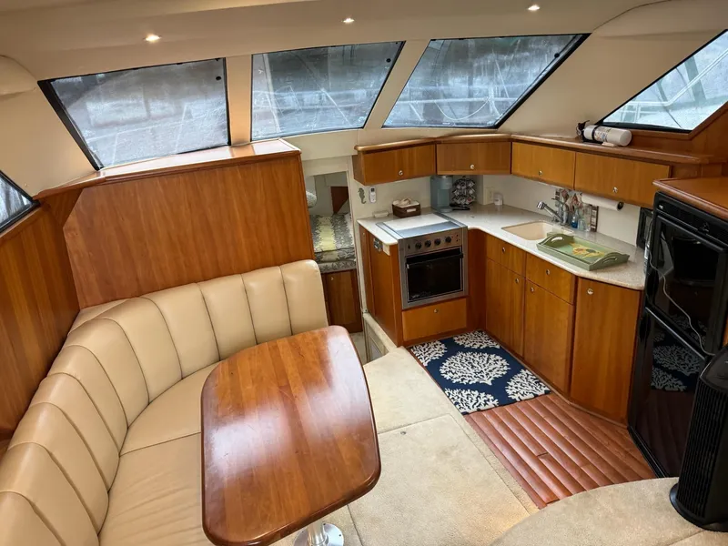 Slide: The Image of Interior of 2002 Silverton 392 Motor Yacht with kitchen and seating area. - 35