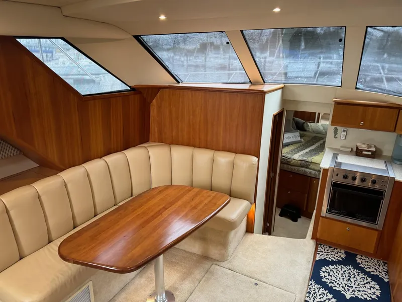 Slide: The Image of Interior of 2002 Silverton 392 Motor Yacht with dining area and kitchen. - 36