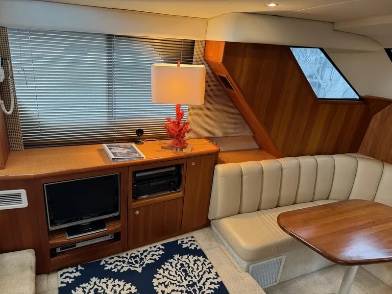 Slide: The Image of Interior of 2002 Silverton 392 Motor Yacht with cozy seating, TV, and elegant decor. - 37
