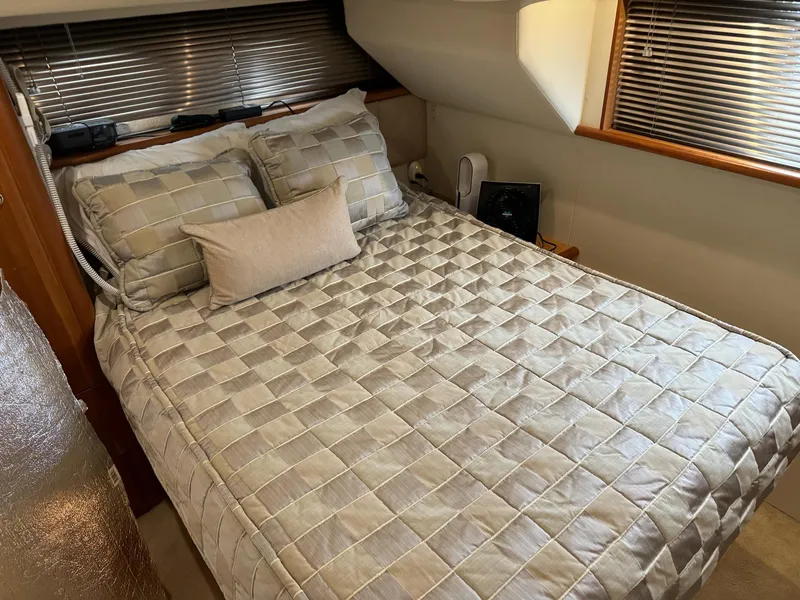 Slide: The Image of Cozy bedroom in 2002 Silverton 392 Motor Yacht with checkered bedding and wooden accents. - 39