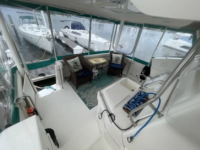 Slide: The Image of 2002 Silverton 392 Motor Yacht interior with seating area and marina view. - 8