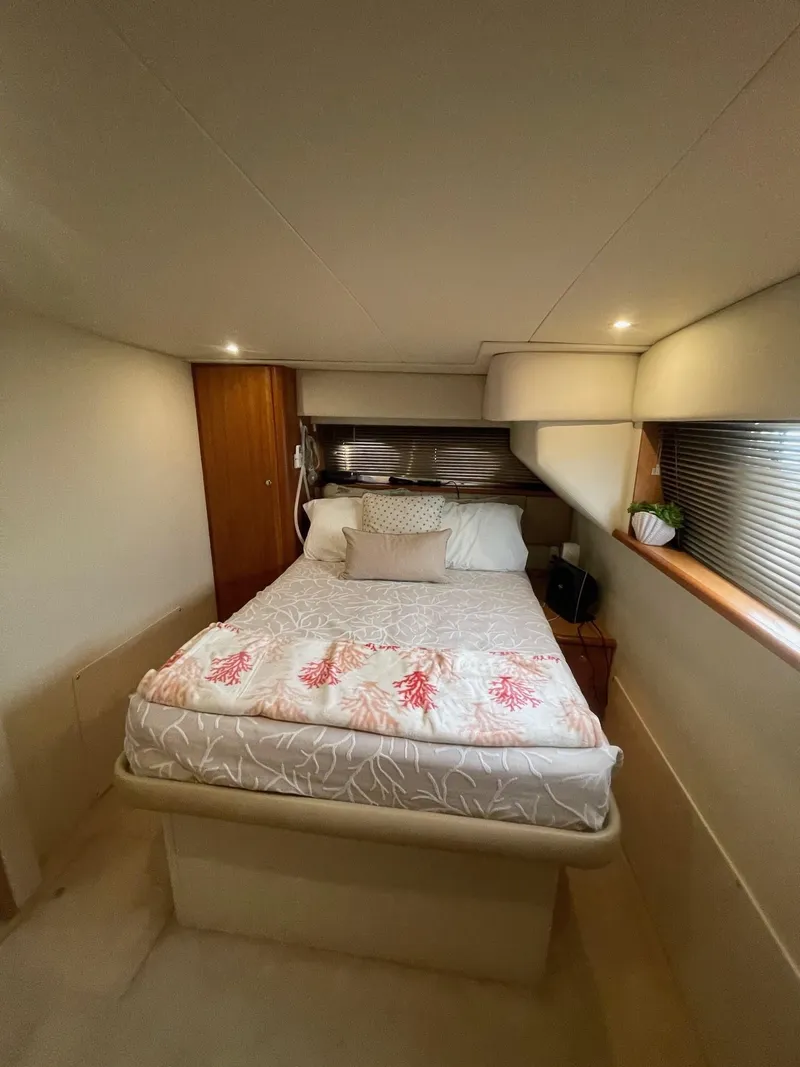 Slide: The Image of 2002 Silverton 392 Motor Yacht bedroom with cozy bed and ambient lighting. - 9