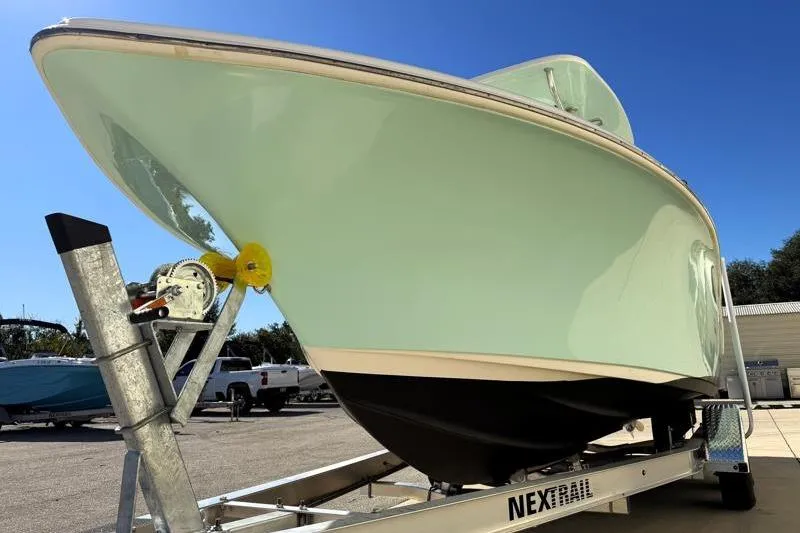 Slide: The Image of 2024 Key West 239 FS boat with Yamaha 250 engine, parked outdoors. - 10