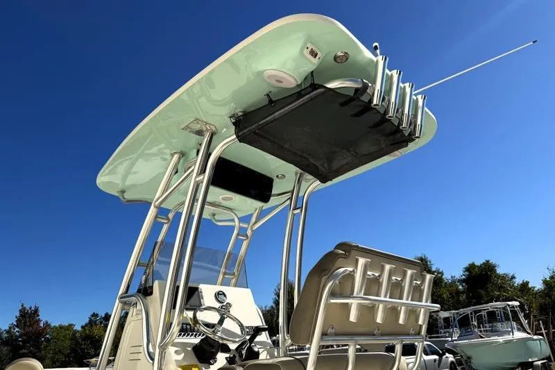 Slide: The Image of 2024 Key West 239 FS boat with T-top and seating, under clear blue sky. - 13