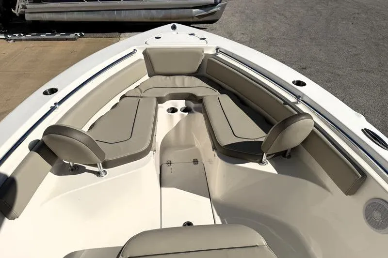 Slide: The Image of 2024 Key West 239 FS boat interior with cushioned seating and cup holders. - 15