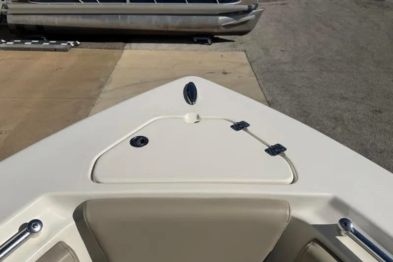 Slide: The Image of 2024 Key West 239 FS boat interior with cushioned seating and sleek design. - 17