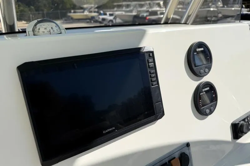 Slide: The Image of Yamaha tachometer and speed fuel gauges on 2024 Key West 239 FS boat dashboard. - 25