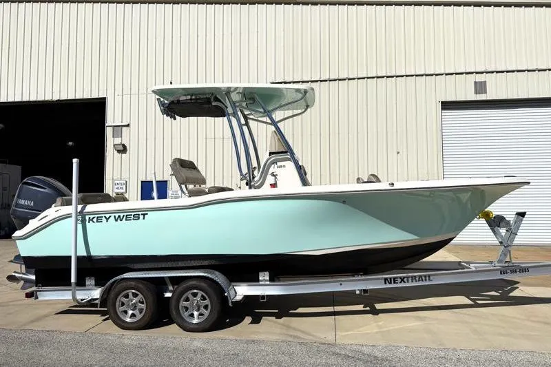 Slide: The Image of 2024 Key West 239 FS boat on trailer, displayed outdoors under clear sky. - 4