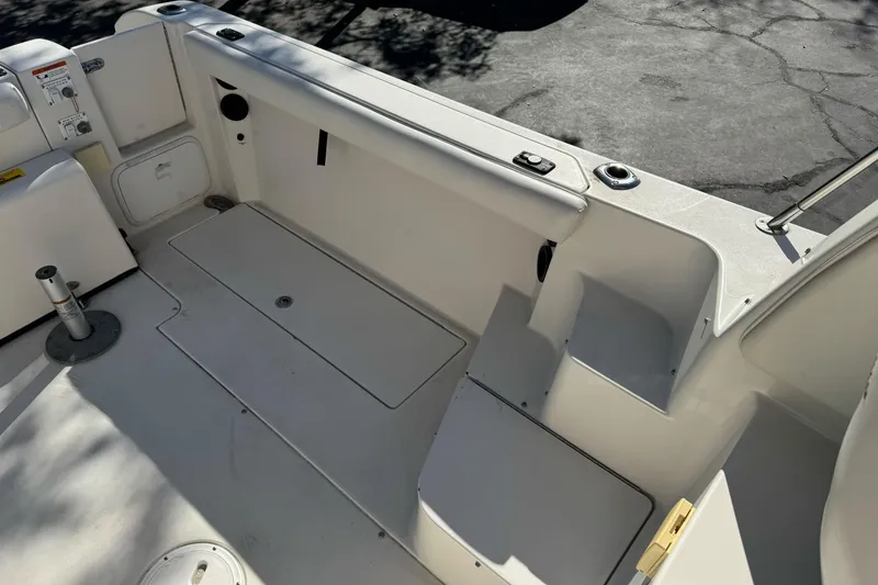 Slide: The Image of 2005 Striper SeaSwirl 2601 boat interior, featuring spacious deck and storage compartments. - 12