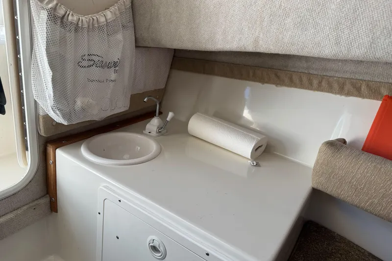 Slide: The Image of 2005 Striper SeaSwirl 2601 boat interior with sink and storage area. - 19