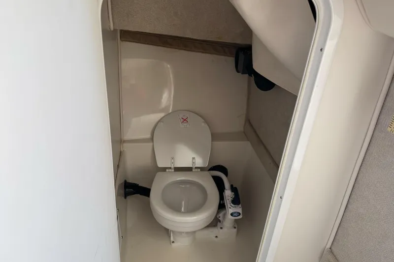 Slide: The Image of 2005 Striper SeaSwirl 2601 boat interior with compact marine toilet. - 21
