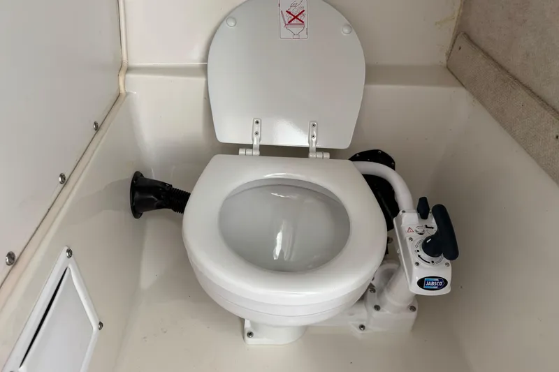 Slide: The Image of Boat toilet in 2005 Striper SeaSwirl 2601, featuring Jabsco manual pump. - 22