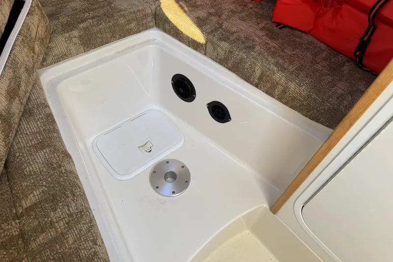 Slide: The Image of 2005 Striper SeaSwirl 2601 boat interior with storage compartment and speakers. - 23