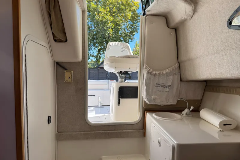 Slide: The Image of Interior view of 2005 Striper SeaSwirl 2601 boat, featuring cabin and seating area. - 24