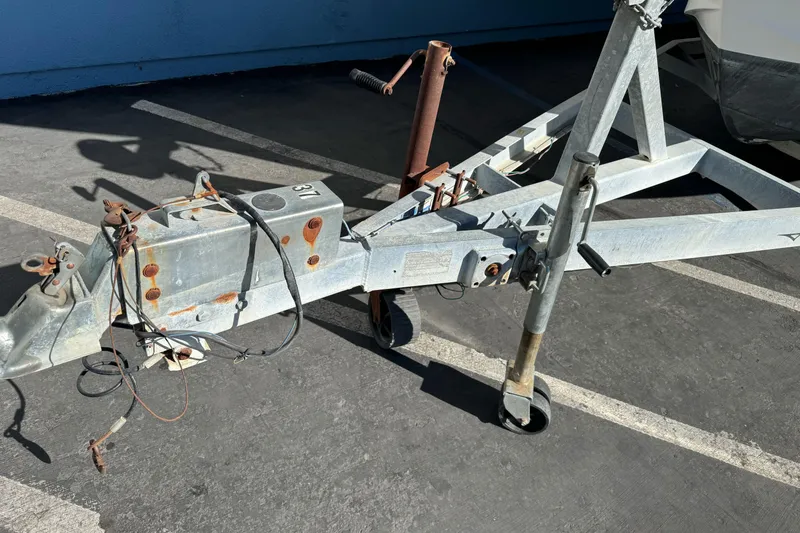 Slide: The Image of Rusty boat trailer hitch for 2005 Striper SeaSwirl 2601 in parking lot. - 4