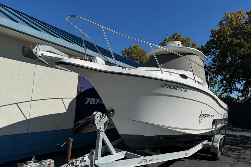 Slide: The Image of 2005 Striper SeaSwirl 2601 boat on trailer, parked outdoors, side view. - 5