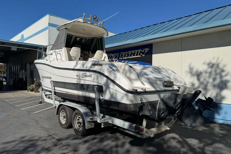 Slide: The Image of 2005 Striper SeaSwirl 2601 boat on trailer outside a building. - 6