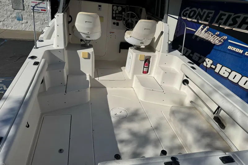 Slide: The Image of 2005 Striper SeaSwirl 2601 boat interior with seating and steering wheel. - 8