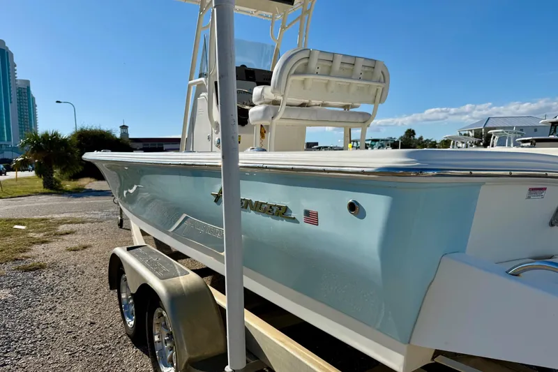 Slide: The Image of 2017 Avenger AV24 boat dashboard with steering wheel and navigation system, parked near buildings. - 11