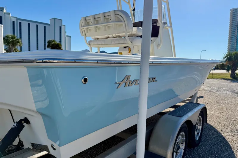 Slide: The Image of Avenger AV24 2017 boat with Suzuki 250 engine, parked near palm trees and other boats. - 12