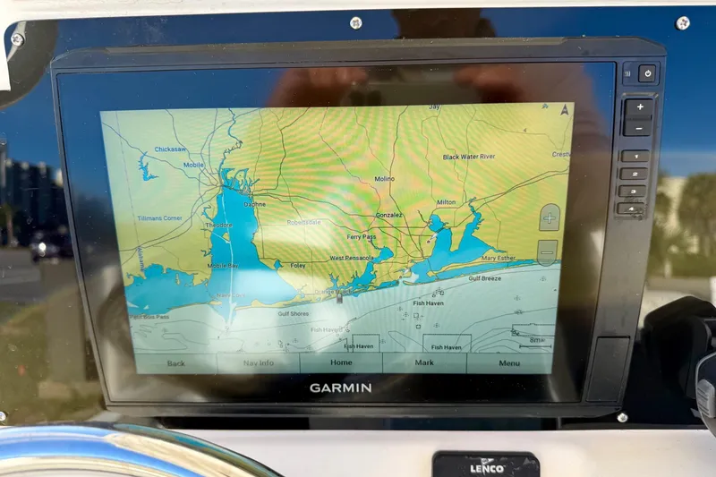 Slide: The Image of 2017 Avenger AV24 boat with modern console and urban backdrop. - 14