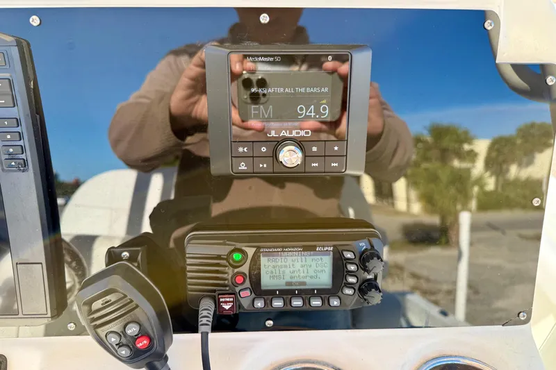 Slide: The Image of 2017 Avenger AV24 boat dashboard with navigation equipment, parked near a road. - 15