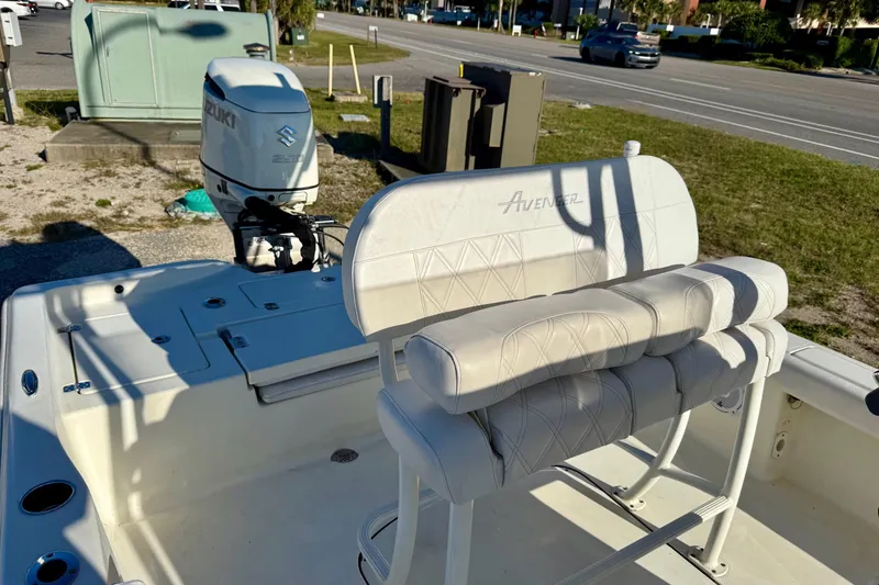 Slide: The Image of 2017 Avenger AV24 boat interior with Suzuki outboard motor, parked near a road. - 19