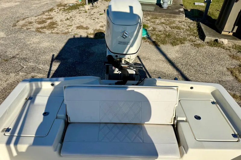 Slide: The Image of 2017 Avenger AV24 boat interior with white seating and Suzuki outboard motor. - 23