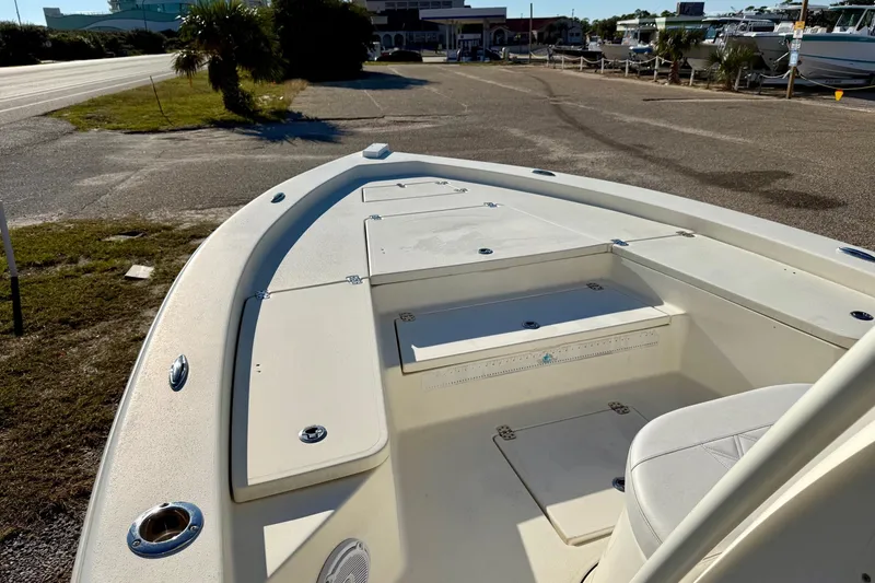 Slide: The Image of 2017 Avenger AV24 boat on trailer, parked in marina with other boats. - 28