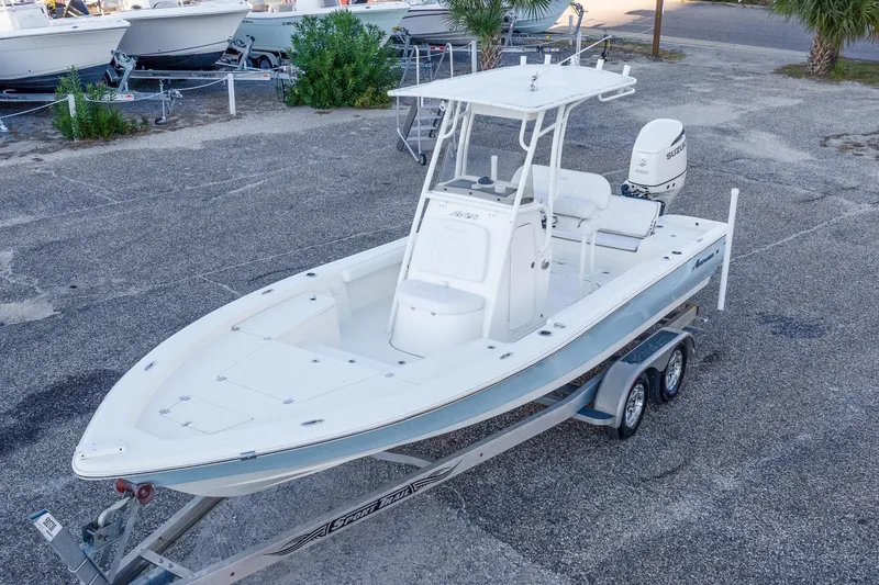 Slide: The Image of 2017 Avenger AV24 boat on trailer, parked in a lot with other boats. - 31