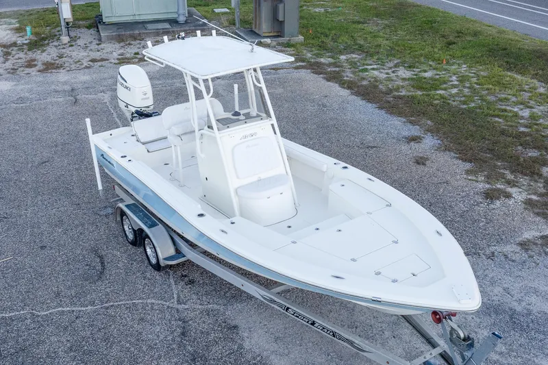 Slide: The Image of 2017 Avenger AV24 boat on trailer, white exterior, parked on gravel lot. - 32