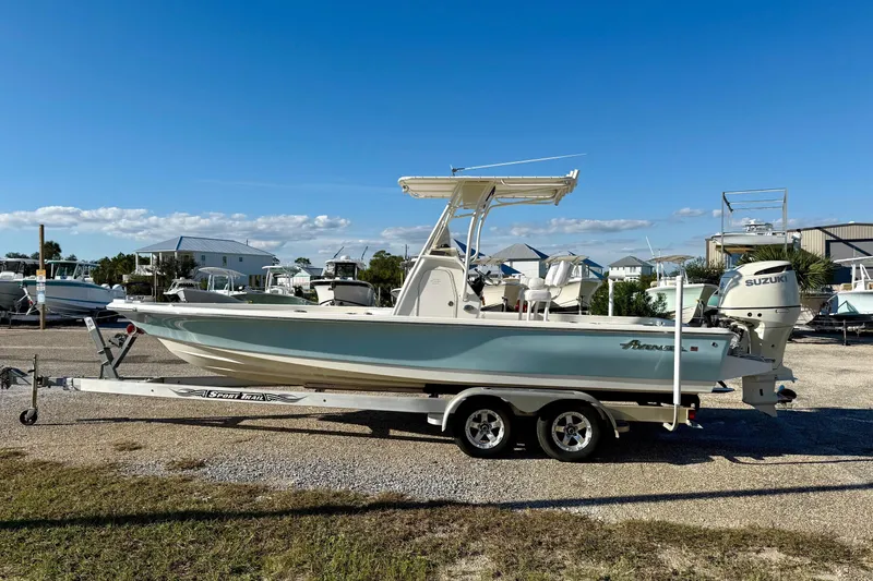 Slide: The Image of 2017 Avenger AV24 boat on trailer, side view, clear sky background. - 8