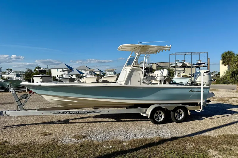 Slide: The Image of 2017 Avenger AV24 boat on trailer, parked outdoors under clear blue sky. - 9