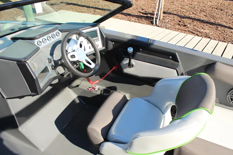 Slide: The Image of 2017 MasterCraft NXT22 boat interior with steering wheel and dashboard controls. - 12