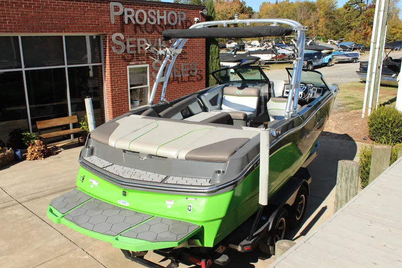 Slide: The Image of 2017 MasterCraft NXT22 boat in vibrant green at a pro shop, ready for sale. - 4