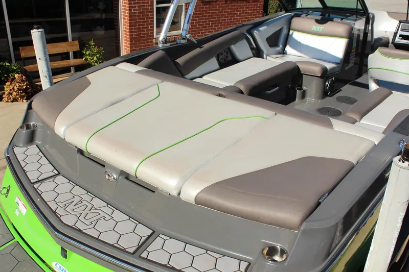 Slide: The Image of 2017 MasterCraft NXT22 boat interior with gray and green seating, showcasing modern design. - 6