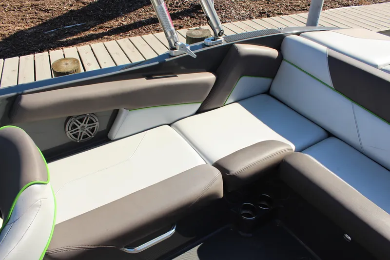 Slide: The Image of 2017 MasterCraft NXT22 boat interior with cushioned seating and speaker detail. - 8