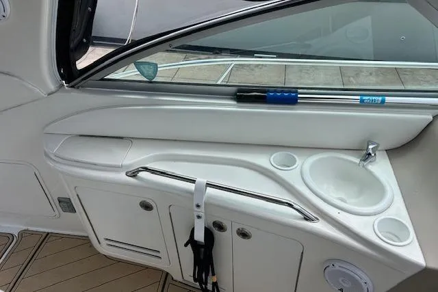 Slide: The Image of 2001 Sea Ray 340 Sundancer interior with sink and storage compartments. - 10