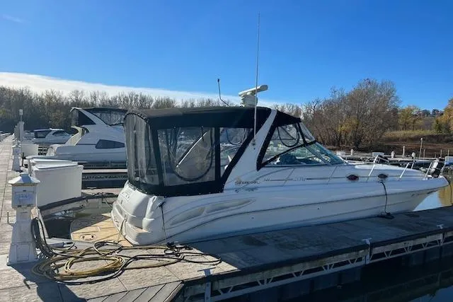 Slide: The Image of 2001 Sea Ray 340 Sundancer docked at marina under clear blue sky. - 2
