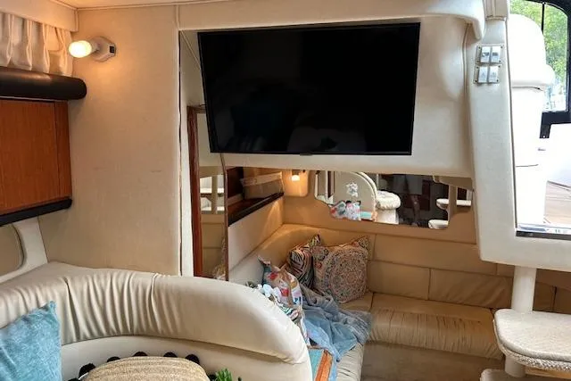 Slide: The Image of Interior of 2001 Sea Ray 340 Sundancer yacht with cozy seating and mounted TV. - 3