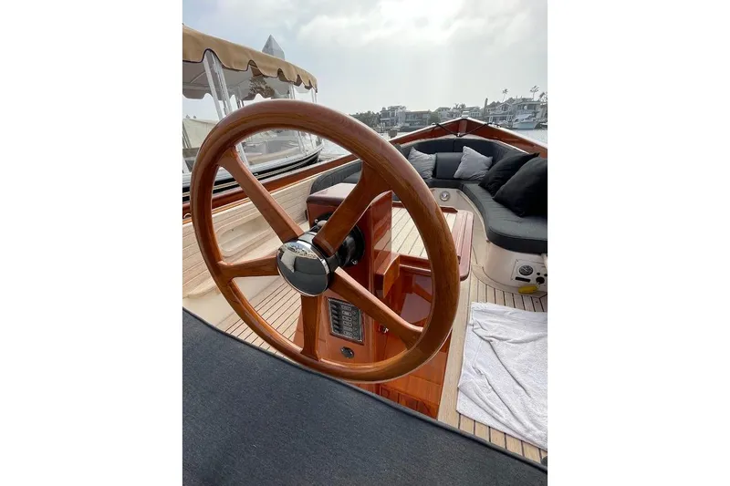 Slide: The Image of Wooden steering wheel on 2001 Wajer Captain's Launch 7m, with cushioned seating and canopy. - 14
