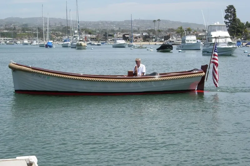 Slide: The Image of 2001 Wajer Captain's Launch 7m boat on calm water with American flag. - 4
