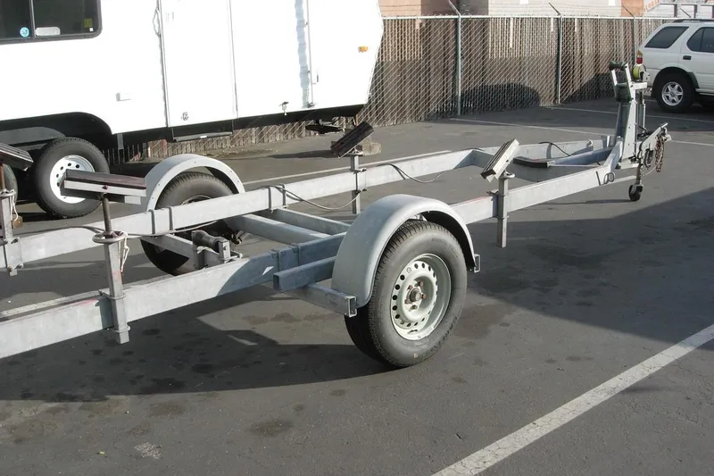 Slide: The Image of Boat trailer for 2001 Wajer Captain's Launch 7m in parking lot. - 7