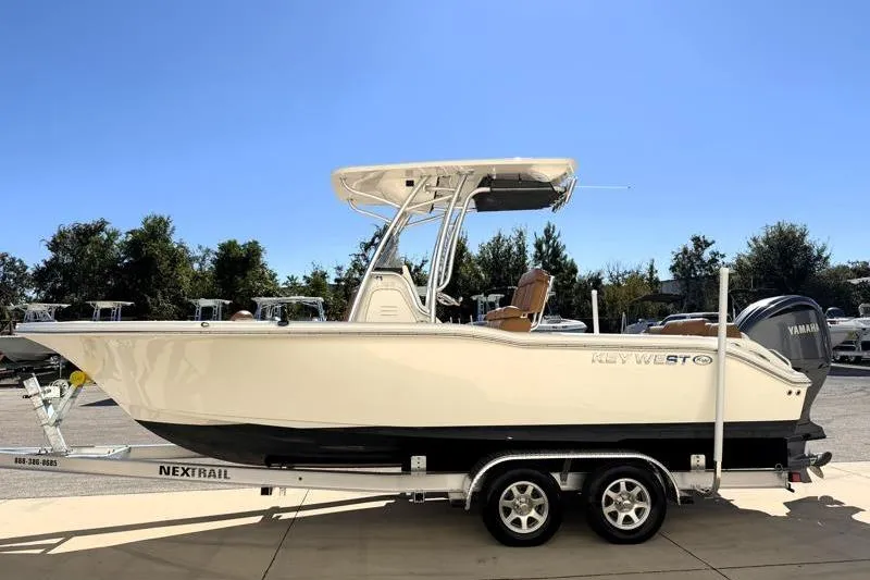 The Image of 2025 Key West 239 FS boat on trailer outside industrial building. - 0