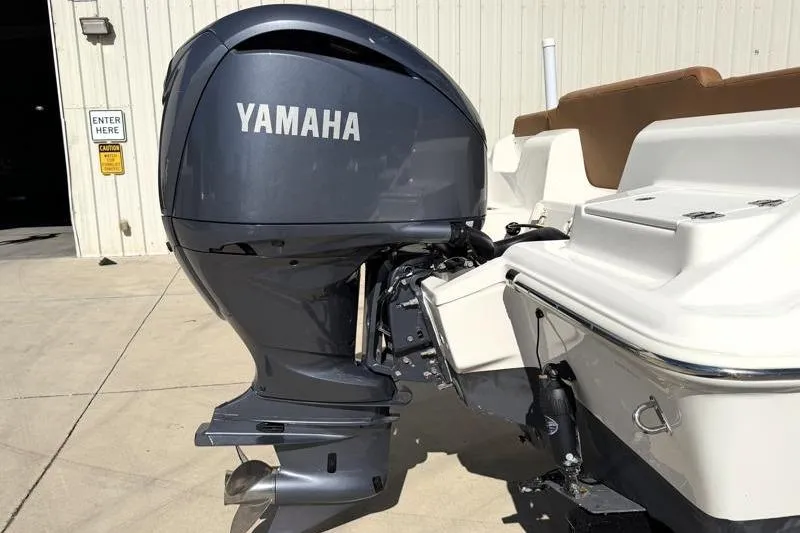 Slide: The Image of 2025 Key West 239 FS boat with Yamaha outboard motor in a sunny setting. - 13