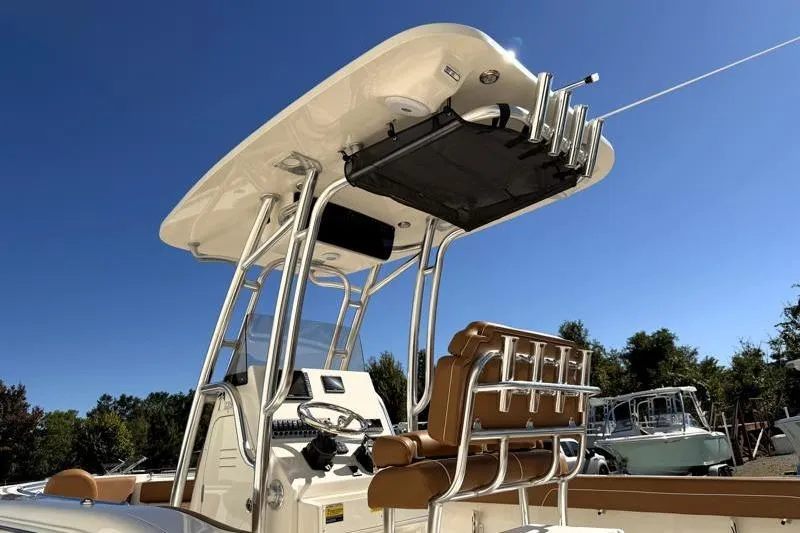 Slide: The Image of 2025 Key West 239 FS boat with T-top and seating, under clear blue sky. - 14